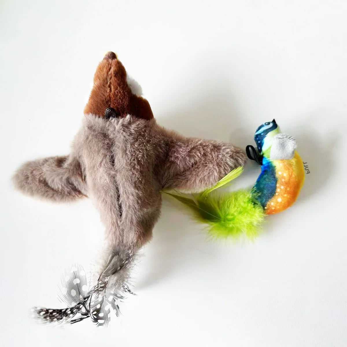 Two plush bird cat toys with feathers.