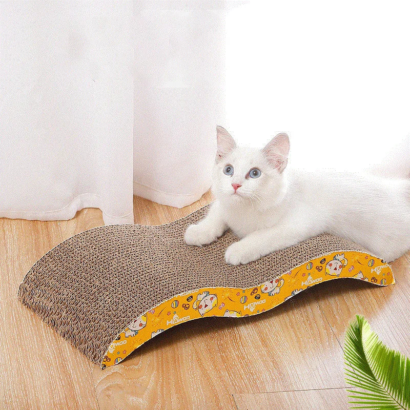 A white cat resting on a corrugated cardboard scratching pad with a yellow patterned border.