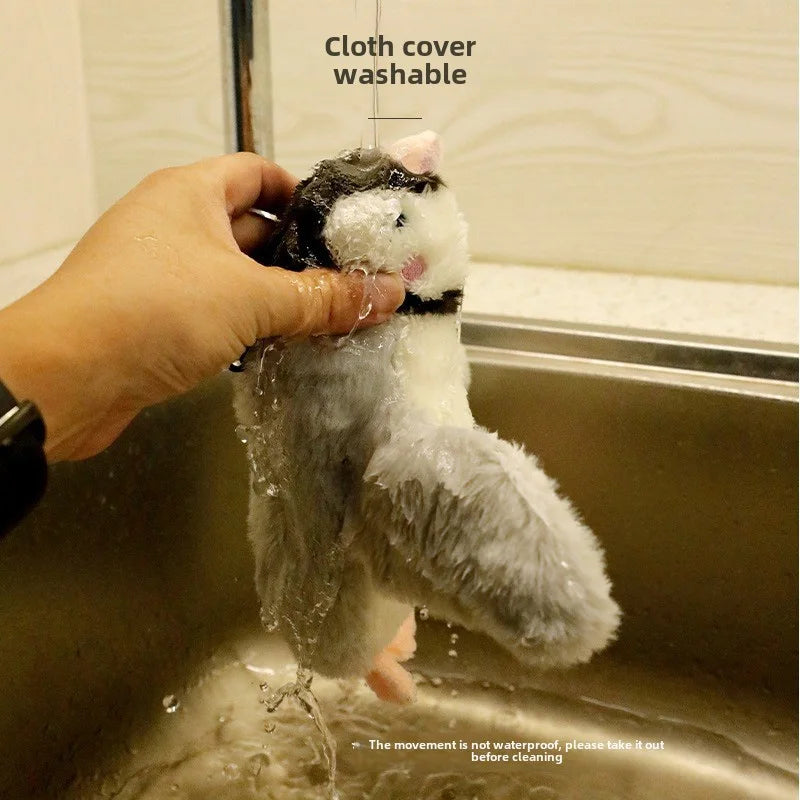 A plush penguin toy being rinsed with water.
